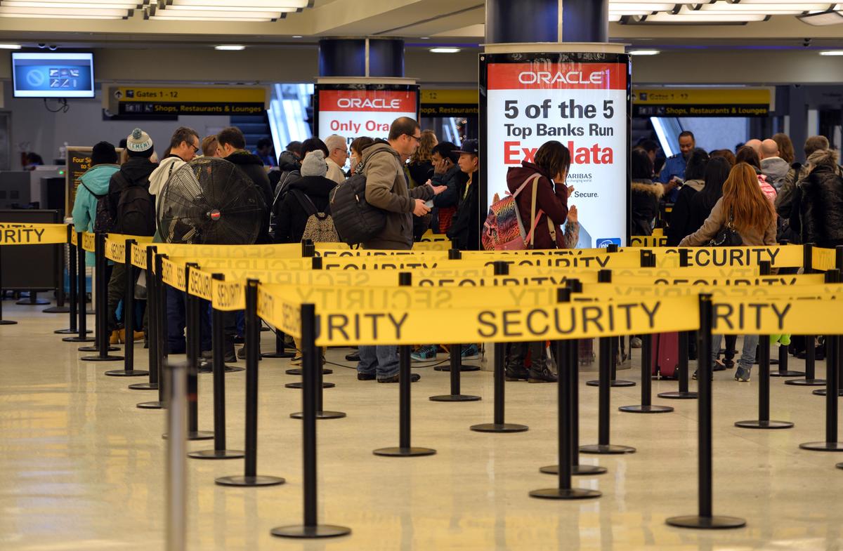 People wait in lines for security check-in at John F. Kennedy International Airport, New York, Jan. 6, 2014. (Stan Honda/Getty Images)