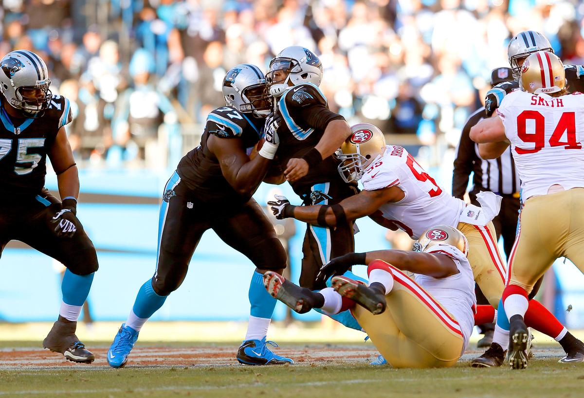 Cam Newton #1 of the Carolina Panthers runs into Byron Bell #77 while being sacked by Ahmad Brooks #55 of the San Francisco 49ers in the third quarter of the NFC Divisional Playoff Game at Bank of America Stadium on January 12, 2014 in Charlotte, North Carolina. (Kevin C. Cox/Getty Images)