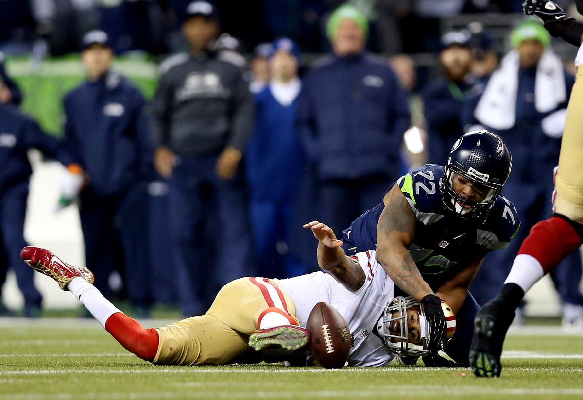 Quarterback Colin Kaepernick #7 of the San Francisco 49ers loses the ball against defensive end Michael Bennett #72 of the Seattle Seahawks in the third quarter during the 2014 NFC Championship. (Christian Petersen/Getty Images)
