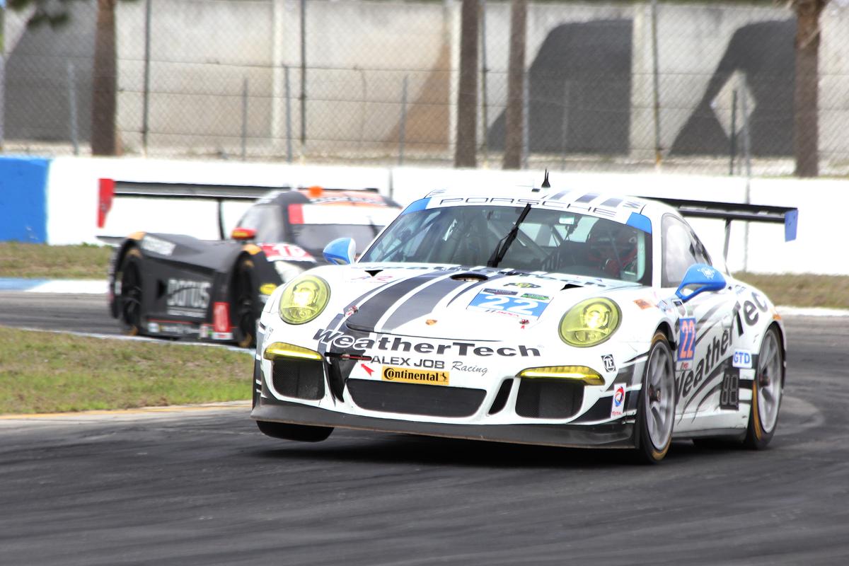 The #23 Alex Job Porsche tries to wheelie around Turn Ten. (Chris Jasurek/Epoch Times)