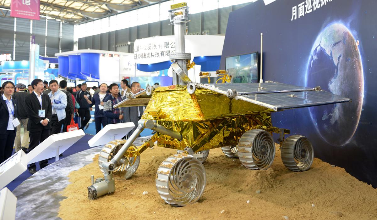 A model of China's moon rover, which recently malfunctioned on the moon, is shown in Shanghai on Nov. 5, 2013. Europe is shown being nuked in an artistic rendition of the Earth used in the display. (Peter Parks/AFP/Getty Images)