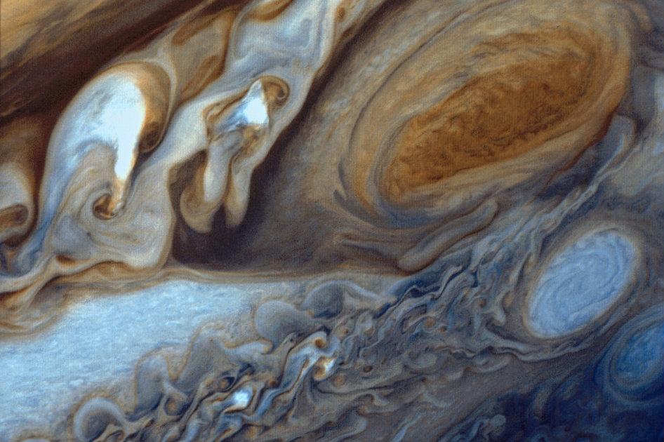 Jupiter's Great Red Spot viewed by Voyager I. At about 89,000 miles in diameter, Jupiter could swallow 1,000 Earths. It is the largest planet in the solar system and perhaps the most majestic. Vibrant bands of clouds carried by winds that can exceed 400 mph continuously circle the planet's atmosphere. (NASA's Goddard Space Flight Center)