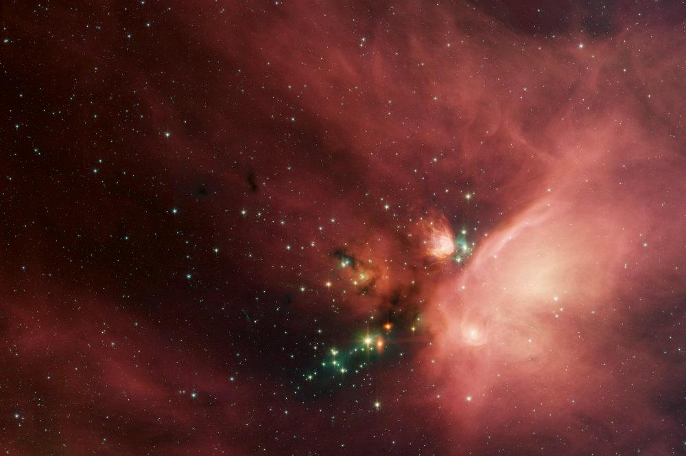 Newborn stars peek out from beneath their natal blanket of dust in this dynamic image of the Rho Ophiuchi dark cloud from NASA's Spitzer Space Telescope. Called "Rho Oph" by astronomers, it's one of the closest star-forming regions to our own solar system. Located near the constellations Scorpius and Ophiuchus, the nebula is about 407 light years away from Earth. (NASA/JPL-Caltech/Harvard-Smithsonian CfA)