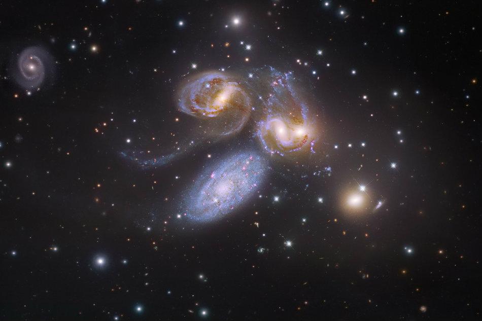 The first identified compact galaxy group, Stephan's Quintet is featured in this remarkable image constructed with data drawn from Hubble Legacy Archive and the Subaru Telescope on the summit of Mauna Kea. The galaxies of the quintet are gathered near the center of the field, but really only four of the five are locked in a cosmic dance of repeated close encounters taking place some 300 million light-years away. (Subaru Telescope (NAOJ), Hubble Legacy Archive, R. Gendler; Image Assembly & Processing: Robert Gendler and Judy Schmidt)