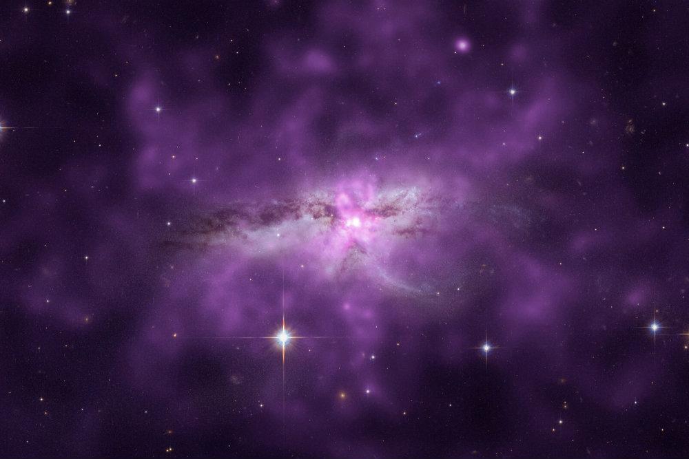 An enormous cloud of hot gas enveloping two large, colliding galaxies. This unusually large reservoir of gas contains as much mass as 10 billion Suns, spans about 300,000 light years, and radiates at a temperature of more than 7 million degrees Kelvin. (X-ray: NASA/CXC/SAO/E.Nardini et al; Optical: NASA/STScI)