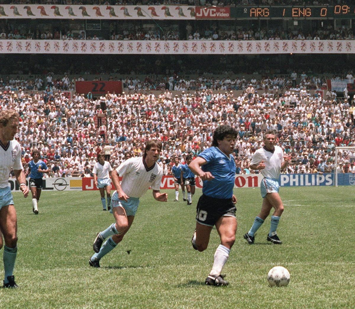 Argentinian forward Diego Armando Maradona runs past English defenders Terry Butcher (L) and Terry Fenwick (2nd L) on his way to scoring his second goal during the World Cup quarterfinal soccer match between Argentina and England 22 June 1986 in Mexico City. (AFP/Getty Images)