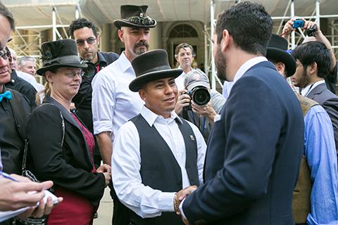 Council member Rafael Espinal (R) shakes hands with Angel Herdez who has been a horse-drawn carriage driver for eight years, on the steps of City Hall in Manhattan on Sept. 10, 2014. (Benjamin Chasteen/Epoch Times)