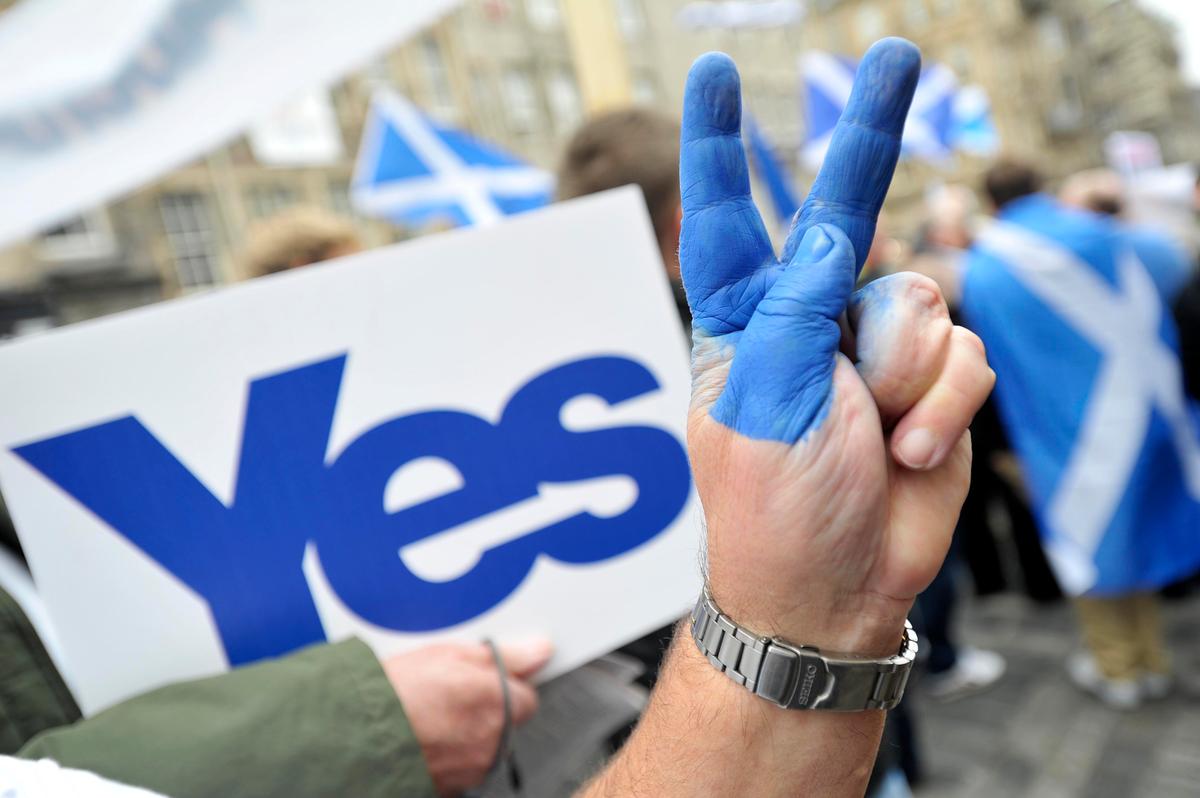 A pro-independence supporter flashes the victory sign as people gather in Edinburgh, Scotland, on Sept. 21, 2013, for a march and rally in support of a "yes" vote in the Scottish Referendum to be held on Sept. 18, 2014. (Andy Buchanan/AFP/Getty Images)