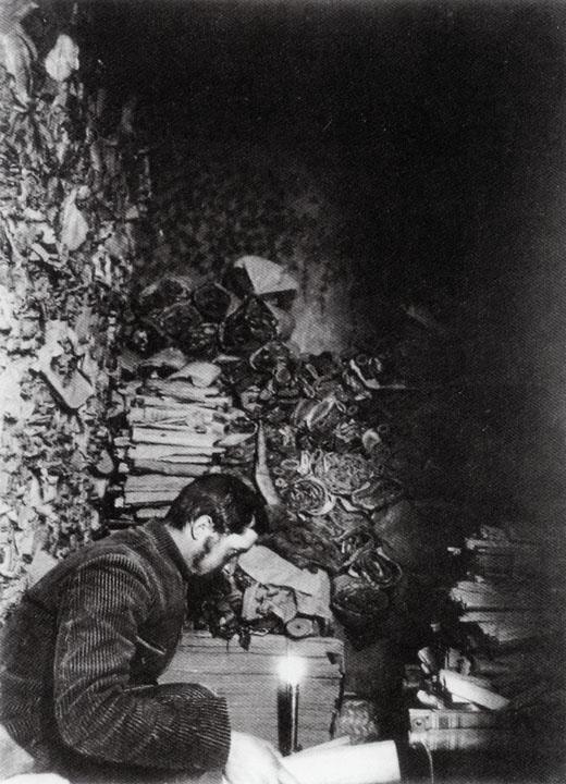 Paul Pelliot examining manuscripts in Cave 17 at the Mogao Caves. (Musée Guimet/Wikimedia Commons)