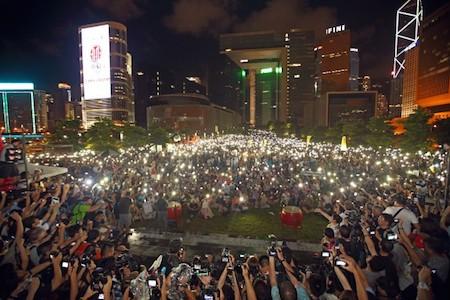 Hong Kong rally on Tamar Park outside the Central Government Offices on Aug 31, 2014, held to protest Beijing's decision to continue to restrict democracy in Hong Kong. Protesters wave lighted mobile phones as candles to show their commitment to civil disobedience. (Poon/Epoch Times)