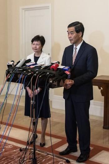 Hong Kong's embattled leader, chief executive Leung Chun-ying (R) and chief secretary Carrie Lam, hold a press conference at Leung's official residence in Hong Kong on Oct. 2, 2014. (Anthony Wallace/AFP/Getty Images)