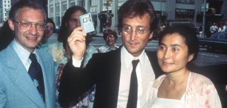 Immigration lawyer Leon Wildes (L) with John Lennon (C) and Yoko Ono (R). Lennon holds up his green card in circa summer of 1976, despite the Nixon administration's efforts to deport him. (Courtesy of Wildes & Weinberg P.C)