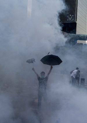 A pro-democracy demonstrator gestures after police fired tear gas towards protesters near the Hong Kong government headquarters on September 28, 2014. (Xaume Olleros/AFP/Getty Images)
