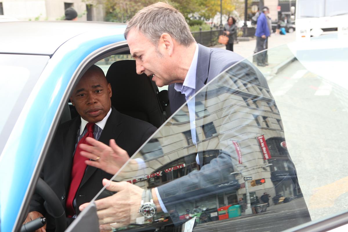 Brooklyn Borough President Eric Adams checks out Car2Go at Borough Hall with Bodo Uebber, Daimler AG board member, Nov. 2014. (Courtesy of Car2Go)