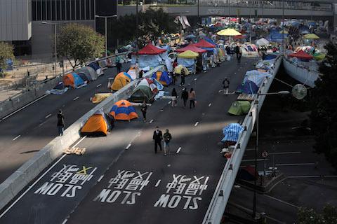 Pro-democracy protesters' tents are seen at the occupied area outside government headquarters in Hong Kong Tuesday, Dec. 9, 2014. (AP Photo/Vincent Yu)