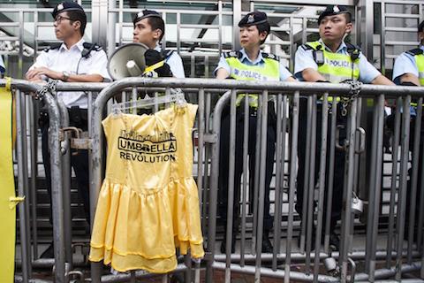 Policemen block the way to the Liaison Government Office in Hong Kong on November 9, 2014. Hundreds of pro-democracy protesters, including leaders of a movement that that has paralysed the streets for weeks, rallied to the city's China office calling for dialogue with Beijing officials. (Xaume Olleros/AFP/Getty Images)