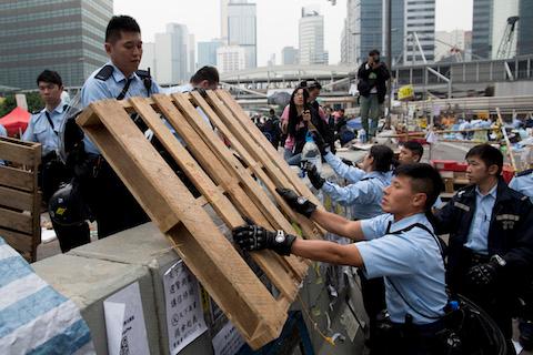 Police officers clear a wooden crate outside Hong Kong's Government complex on December 11, 2014 in Hong Kong. (Brent Lewin/Getty Images)