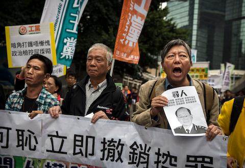 Pro-democracy demonstrators chant as they march during a demonstration against the arrest of protest marshalls by police the night before, at the Admiralty protest site on November 13, 2014 in Hong Kong, Hong Kong. Hong Kong's high court has authorized police to arrest protesters who obstruct bailiffs on the three interim restraining orders. (Photo by Kevin Frayer/Getty Images)