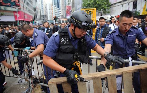 Police clear away the pro-democracy protest camp in the Causeway Bay district of Hong Kong on December 15, 2014. (Isaac Lawrence/AFP/Getty Images)