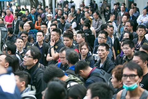 The anti-Triad police stand by as protest leaders speak to students about leaving the area around the CITIC Tower at the Admiralty protest site in Hong Kong on Nov. 18, 2014. (Benjamin Chasteen/Epoch Times)