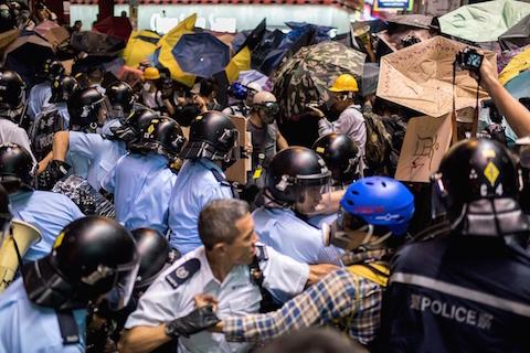 Police officers beat back pro-democracy protesters in the Mongkok district of Hong Kong on Nov. 25, 2014.  (Alex Ogle/AFP/Getty Images)