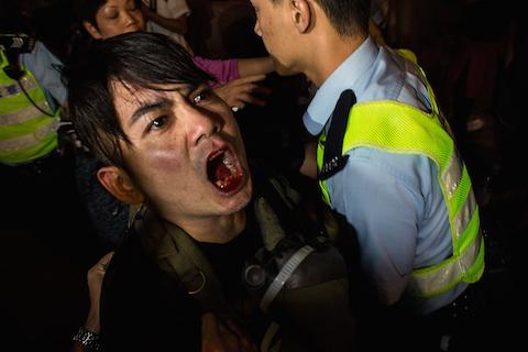 Riot police retain a man during clash with protesters at Mong Kok on Nov. 25, 2014 in Hong Kong. (Lam Yik Fei/Getty Images)