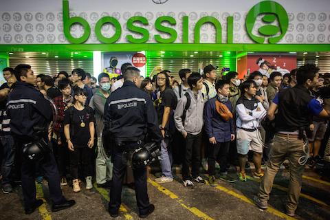 Pro-democracy protesters and pedestrians are stopped from entering a street by police in Mong Kok on November 26, 2014 in Hong Kong. (Chris McGrath/Getty Images)
