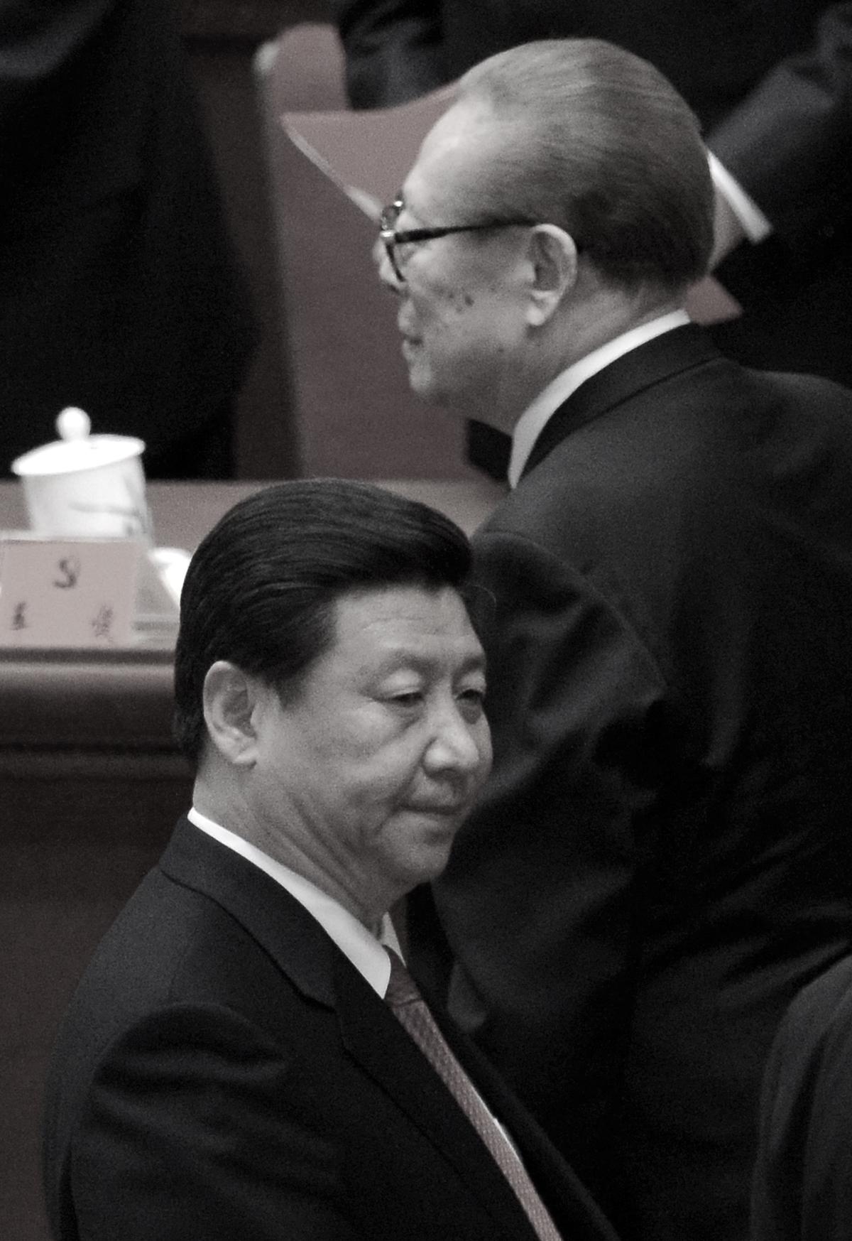 Former Chinese Communist Party head Jiang Zemin (R) walks by Xi Jinping (L) after the closing of the 18th Communist Party Congress at the Great Hall of the People in Beijing on Nov. 14, 2012. At this Party Congress Xi was formally appointed to head the CCP. (Wang Zhao/AFP/Getty Images)