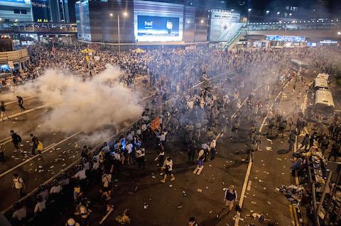 Demonstrators disperse as tear gas is fired by police during a protest on Sept. 28, 2014, in Hong Kong. (Anthony Kwan/Getty Images)