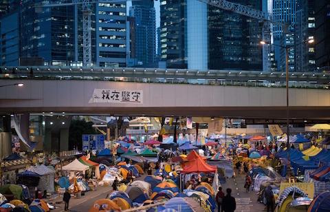 People walk down a street at the pro-democracy movement's main protest site in the Admiralty district of Hong Kong on Dec. 4, 2014. (Johannes Eisele/AFP/Getty Images)