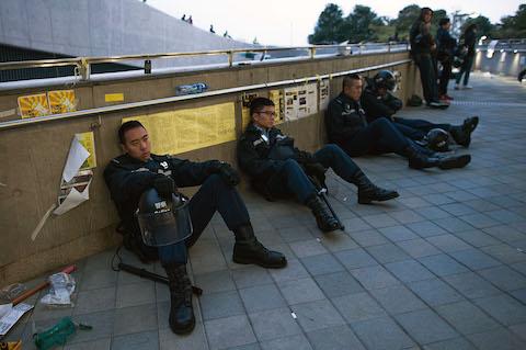 Police officers rest on the floor outside the Legislative Council building after clashes with pro-decmocracy protesters on November 19, 2014 in Hong Kong. (Anthony Kwan/Getty Images)