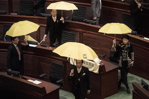 Pro-democracy lawmakers walk out in protest before the policy address of Hong Kong Chief Executive Leung Chun-ying in the legislative council in Hong Kong on Jan. 14, 2015. (Philippe Lopez/AFP/Getty Images)