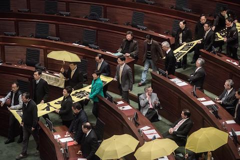 Pro-democracy lawmakers walk out in protest before the policy address of Hong Kong Chief Executive Leung Chun-ying in the legislative council in Hong Kong on Jan. 14, 2015. (Philippe Lopez/AFP/Getty Images)