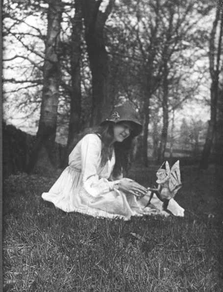 The second of the five photographs, showing Elsie with a winged gnome. (<a href="http://en.wikipedia.org/wiki/File:CottingleyFairies2.jpg" target="_blank">Wikimedia Commons</a>)