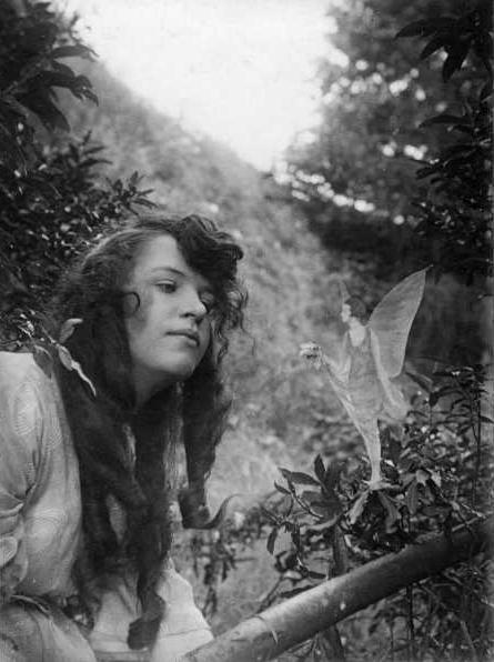 The fourth photograph, "Fairy Offering Posy of Harebells to Elsie." (<a href="http://en.wikipedia.org/wiki/File:CottingleyFairies4.jpg" target="_blank">Wikimedia Commons</a>)