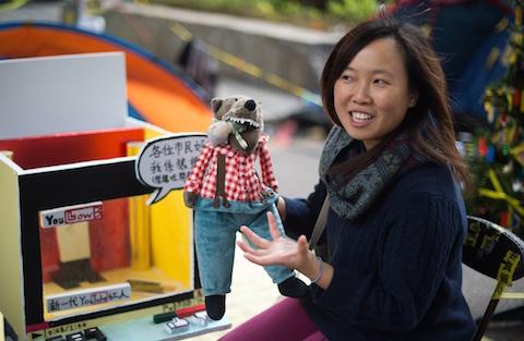 Artist Helen Fan, one of the founders of an online glossary Umbrella Terms, holds a "Lufsig," a toy wolf used as a symbol of opposition to the government and chief executive Leung Chun-ying at the main Admiralty protest site in Hong Kong on Dec. 4, 2014. (Johannes Eisele/AFP/Getty Images)