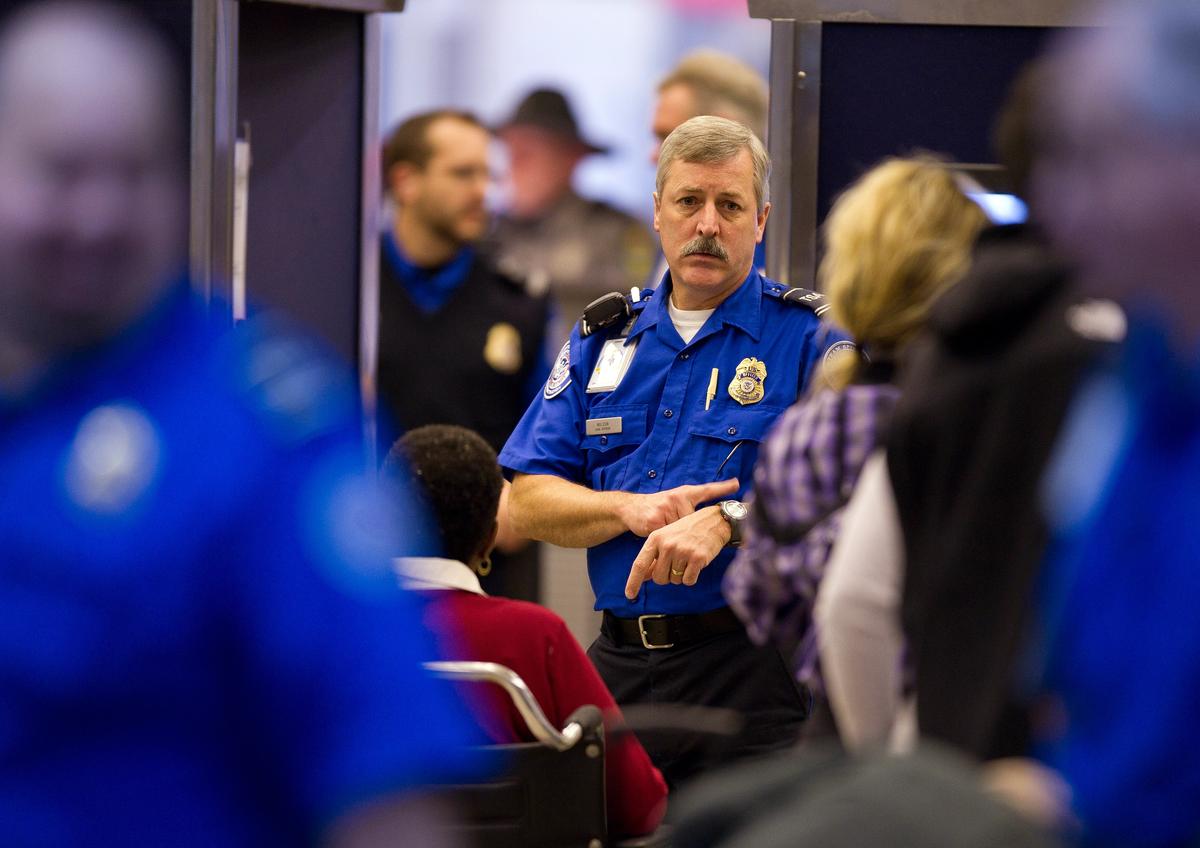 A TSA agent instructs travelers through the security lines at the Pittsburgh International Airport on Nov. 24, 2010. (Jeff Swensen/Getty Images)