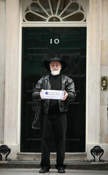 Author Terry Pratchett poses for photographs outside Number 10 Downing Street on November 26, 2008 in London. Mr Pratchett, who was recently diagnosed with Alzheimers, handed in a petition on behalf of the Alzheimer's Research Trust calling for an increase in government funding for dementia research. (Photo by Peter Macdiarmid/Getty Images)