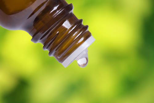 Aromatherapy is an effective healing agent especially for reducing stress and improving mood. (<a href="http://www.shutterstock.com/pic-80572300/stock-photo-macro-shot-of-a-bottle-with-drop-with-fresh-foliage-in-the-background-focus-on-bottle.html?src=K2cbMDr7NdgBDgJXCjCfQw-1-29" target="_blank" rel="noopener">Shutterstock</a>)