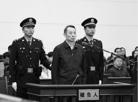 Jiang Jiemin, former head of the State-owned Assets Supervision and Administration Commission, stands trial at Hanjiang Intermediate People's Court on April 13, 2015. (Screen shot/Xinhua)