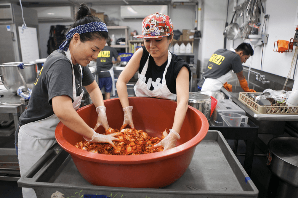 Mokbar chef and owner Esther Choi (L) with sous-chef Michelle Yeom make kimchee. (Samira Bouaou/Epoch Times)