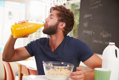 The problem with fruit juice, is that it's like fruit except with all of the good stuff taken out. (<a href="http://www.shutterstock.com/pic-267555668/stock-photo-young-man-eating-breakfast-and-drinking-orange-juice.html?src=cCIIhJ9A7tcDZm_UxKdEKg-1-62" target="_blank">Shutterstock</a>)