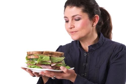 Whole wheat bread might contain a little more fiber and some more nutrients, but there really isn't much difference when it hits your system. (<a href="http://www.shutterstock.com/pic-5787337/stock-photo-pretty-brunette-holding-a-plate-with-a-very-healthy-sandwich-in-her-hands.html?src=h8r_c7kfqz1HGmpj2WeIZQ-1-145" target="_blank">Shutterstock</a>)