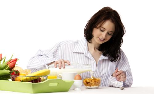 So-called "healthy" cereals are the worst foods you can possibly eat at the start of the day. (<a href="http://www.shutterstock.com/pic-73960087/stock-photo-young-woman-at-breakfast-pouring-milk-in-corn-flakes.html?src=qEJvsw_gP8knorePxWbzug-1-67" target="_blank">Shutterstock</a>)