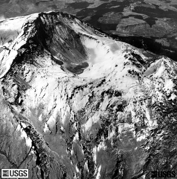 The crater area dropped in relation to the summit, and the growing bulge (right) shows pronounced fracturing because of its increased expansion, prior to the eruption of Mount St. Helens. (USGS)