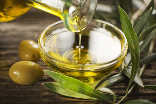 Extra virgin olive oil is the healthiest fat on the planet. (<a href="http://www.shutterstock.com/pic-193533122/stock-photo-bottle-pouring-virgin-olive-oil-in-a-bowl-close-up.html?src=ZpIcvdzxEJ8YKFRf6u_APA-1-1" target="_blank">Shutterstock</a>)