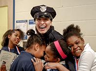  Community Policing Officer Jackelyn Burgos with Cleveland Public School children at conclusion of G.R.E.A.T. program. (Courtesy of Cuyahoga Metropolitan Housing Police Department)