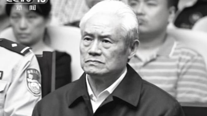 In this image taken from video released by China's CCTV, Zhou Yongkang, formerly the Chinese Communist Party Politburo Standing Committee member in charge of security, sits in a courtroom at the the First Intermediate People's Court of Tianjin in Tianjin, China, Thursday, June 11, 2015. (AP Photo/CCTV via AP Video)