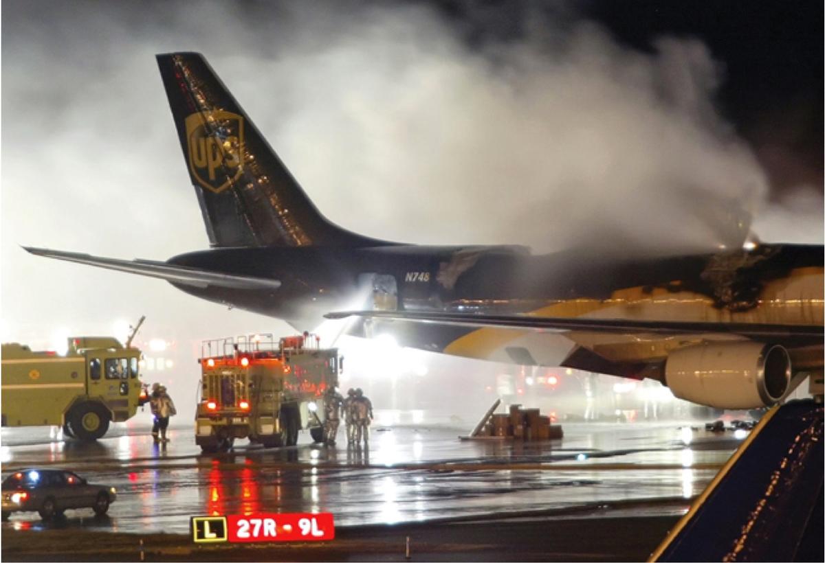 An emergency crew arrives on the scene where a UPS 747-400 Boeing cargo plane caught fire due to lithium ion batteries in Dubai on Sept. 5, 2010. (Courtesy of National Safety Transport Board)