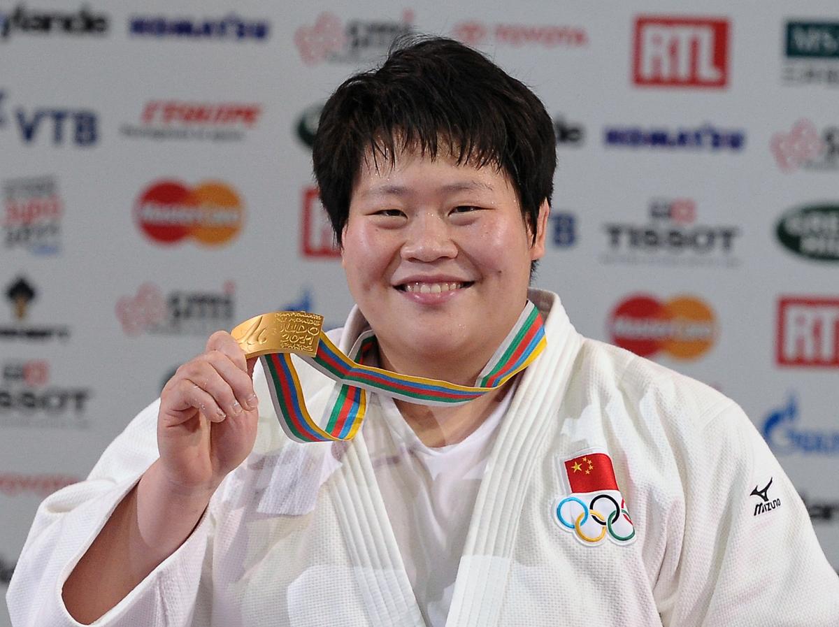 China's Tong Wen celebrates her gold medal during the podium ceremony for the + 78kg category at the Judo World Championships, on August 27, 2011 in Paris. (BERTRAND LANGLOIS/AFP/Getty Images)